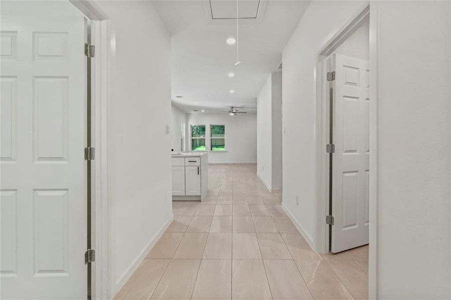 Hall with recessed lighting and attic access