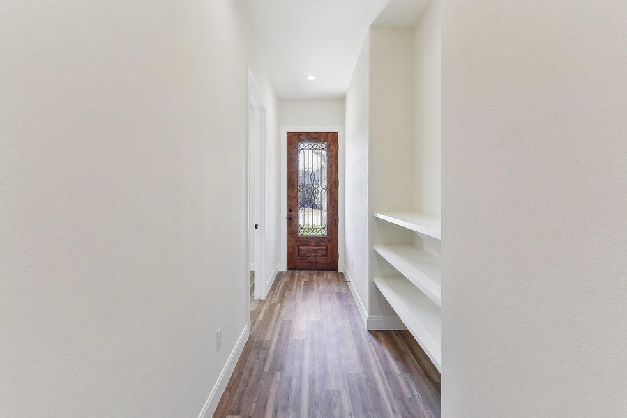 Doorway featuring recessed lighting, baseboards, and dark wood-style floors Doorway featuring recessed lighting, baseboards, and dark wood-style floors