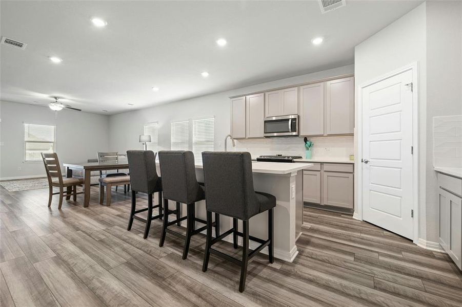 Side Plank Flooring -- Open Eat-in Kitchen is Perfect for Entertaining and Interacting with Family While Preparing Meals.