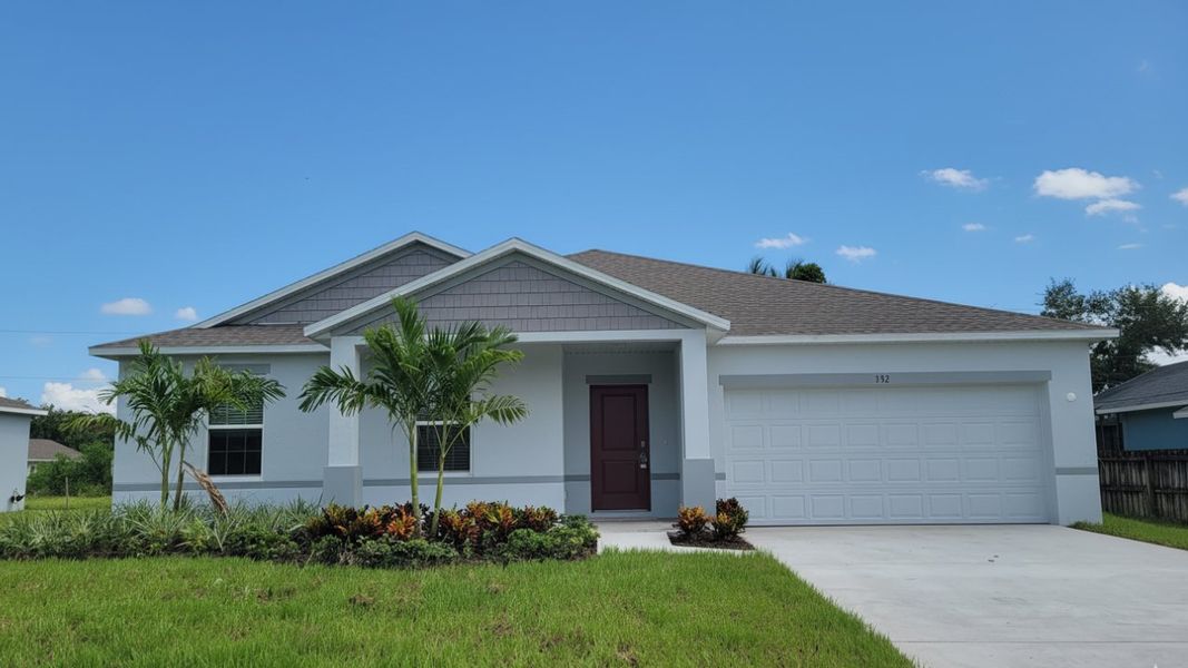 Front exterior of a new home in Port St. Lucie, Port St. Lucie, FL, highlighting curb appeal (Image 1).
