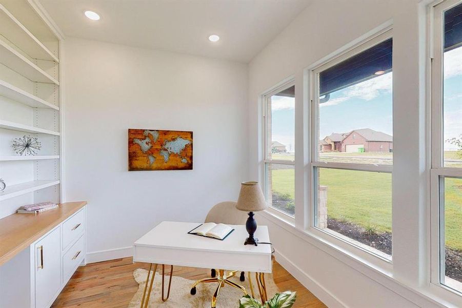 Office area with a wealth of natural light and light hardwood / wood-style floors