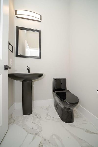 Bathroom with baseboards and light marble finish floors Bathroom with baseboards and light marble finish floors
