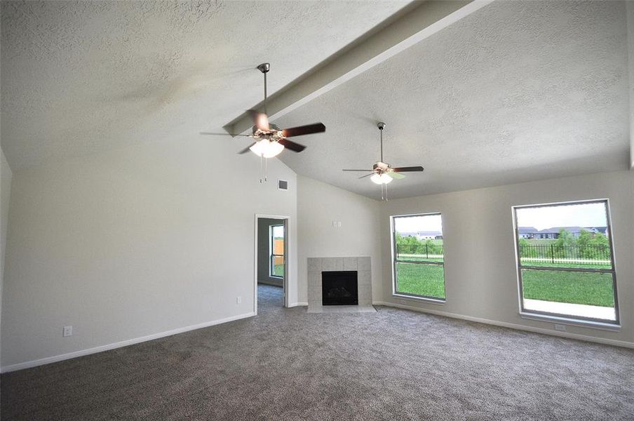 The Family room cathedral ceiling with a center beam and 2 extended ceiling fans.