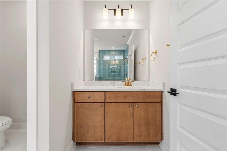This sleek bathroom features a single vanity, offe