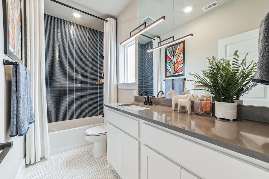 Full bath featuring vanity, shower / bathtub combination with curtain, light tile patterned floors, and recessed lighting