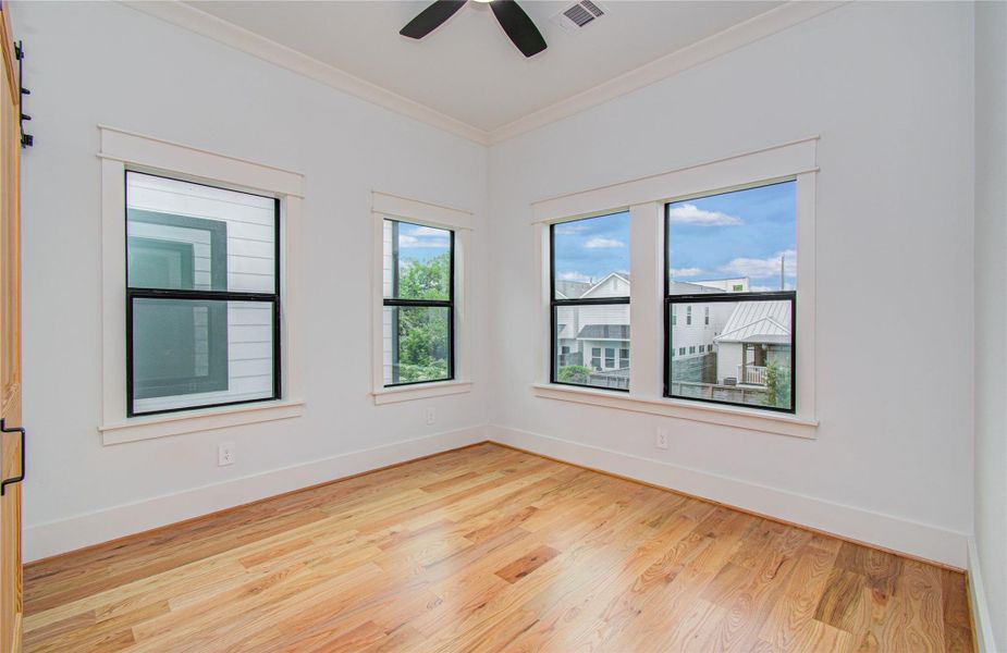 Bright Third Bedroom features hardwood floors, large windows for natural light.