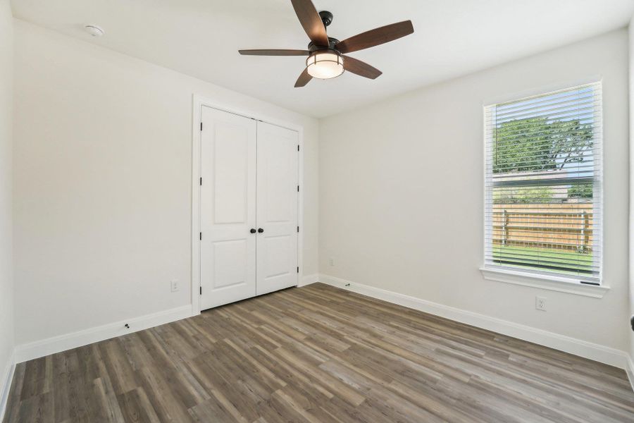 Bedroom 2 featuring baseboards, wood-style vinyl flooring, a closet, and ceiling fan Bedroom 2 featuring baseboards, wood-style vinyl flooring, a closet, and ceiling fan