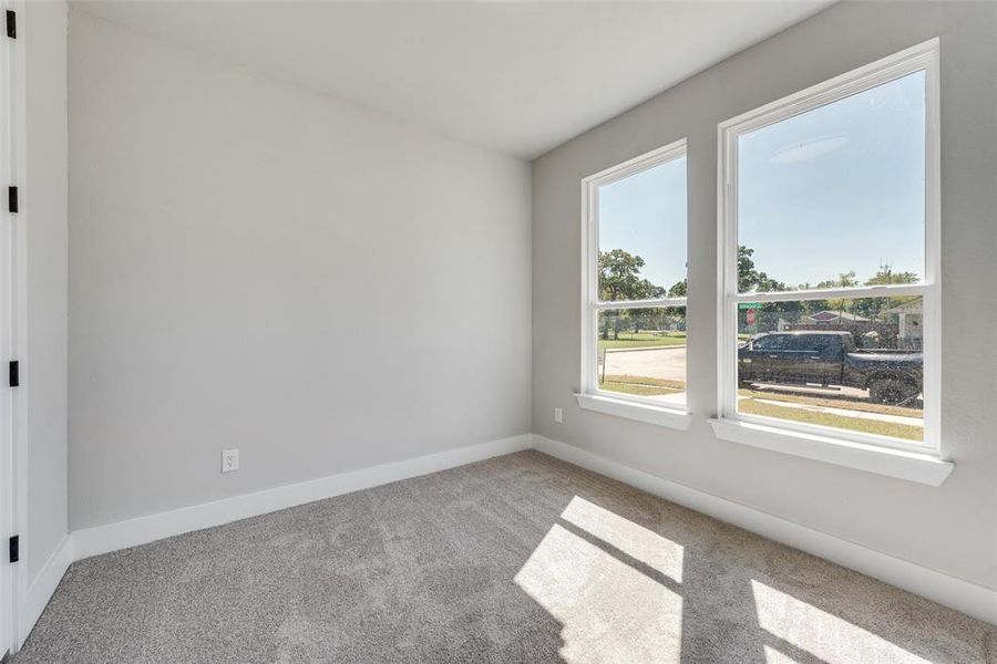 Carpeted spare room with a healthy amount of sunlight