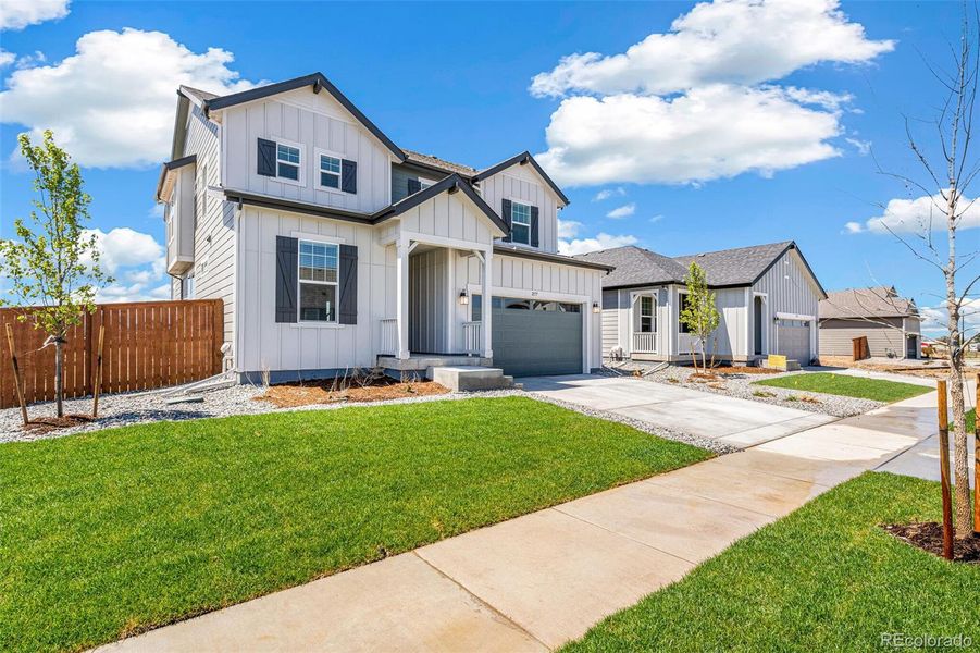 Front exterior of a new home in Farmlore, Brighton, CO, highlighting curb appeal (Image 20).