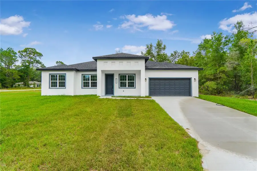 Front exterior of a new home in , Dunnellon, FL, highlighting curb appeal (Image 1). Front exterior of a new home in , Dunnellon, FL, highlighting curb appeal (Image 1).