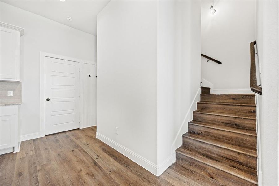 Stairs featuring wood-type flooring