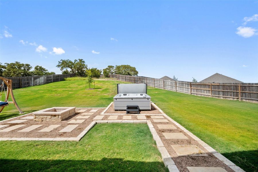 Fenced backyard with an outdoor fire pit