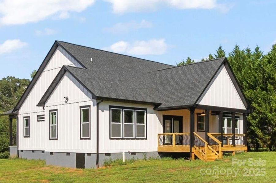 View from rear of home. Gorgeous over size covered rear deck. Large crawlspace area. extra storage