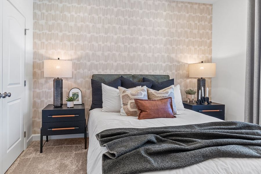 A bed with a blanket on it.