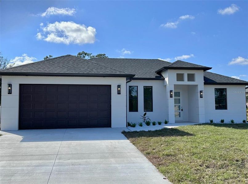 Front exterior of a new home in , North Port, FL, highlighting curb appeal (Image 1). Front exterior of a new home in , North Port, FL, highlighting curb appeal (Image 1).