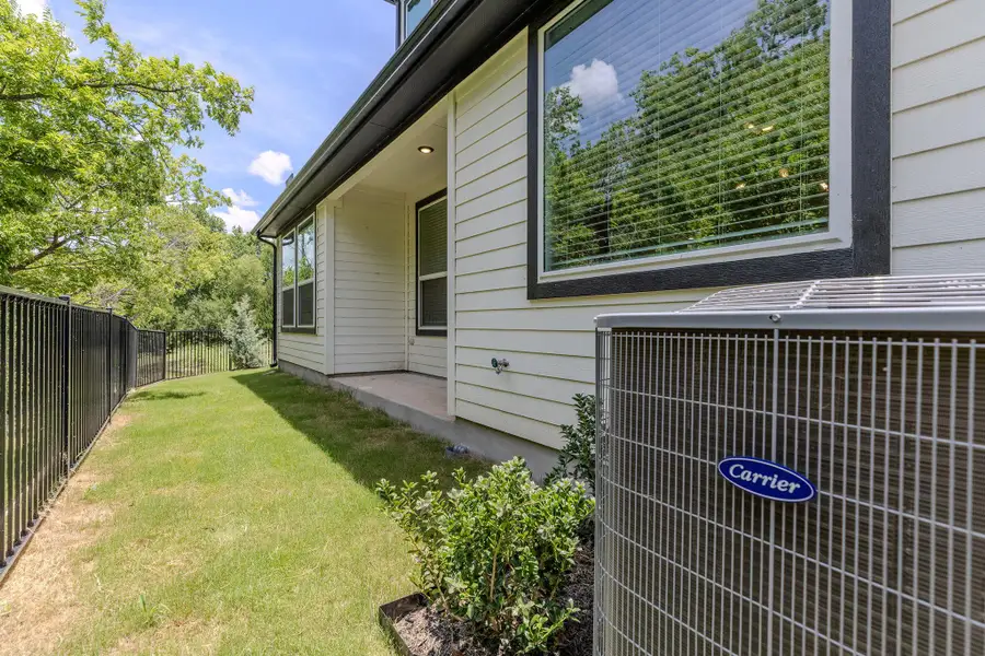 A private side yard with a sturdy fence borders the house, offering a tranquil outdoor retreat. A private side yard with a sturdy fence borders the house, offering a tranquil outdoor retreat.