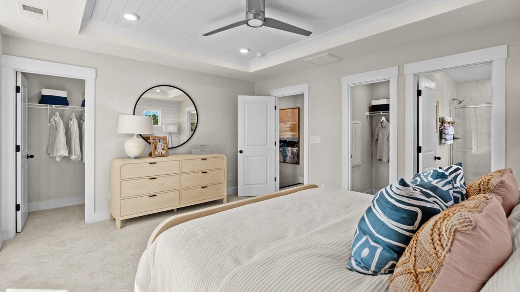 Primary suite with walk-in closet & en suite bathroom in a DRB Homes Brookgreen model home Primary suite with walk-in closet & en suite bathroom in a DRB Homes Brookgreen model home