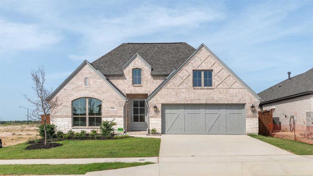 View of front facade with a garage and a front yard