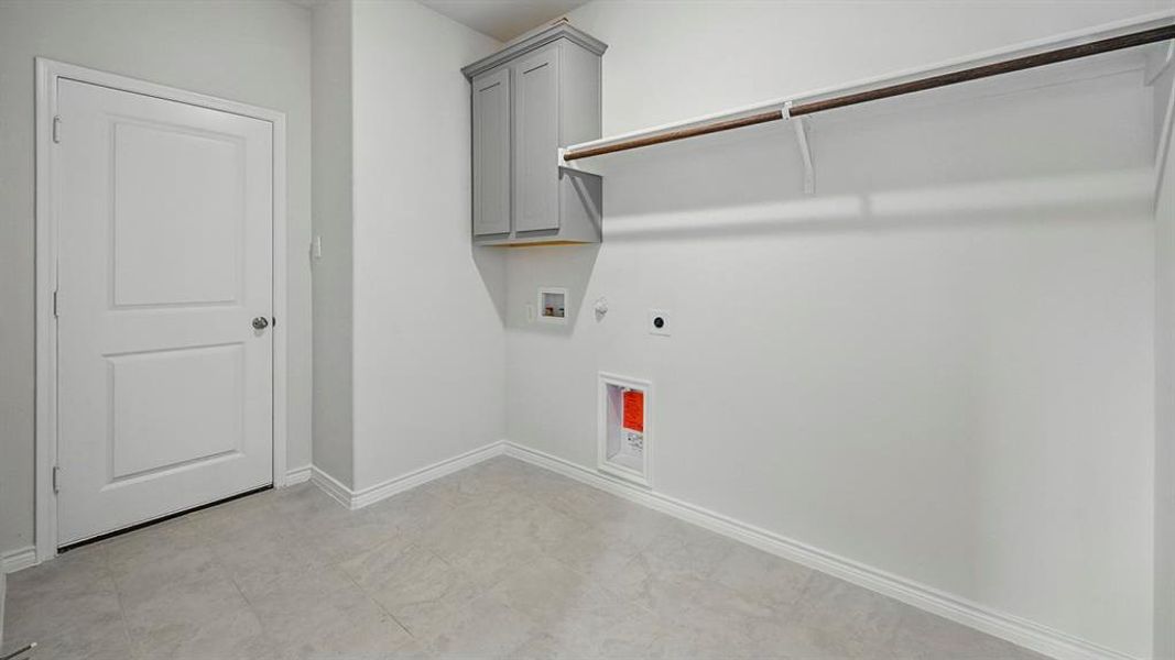 Washroom featuring hookup for a gas dryer, cabinet space, washer hookup, and hookup for an electric dryer