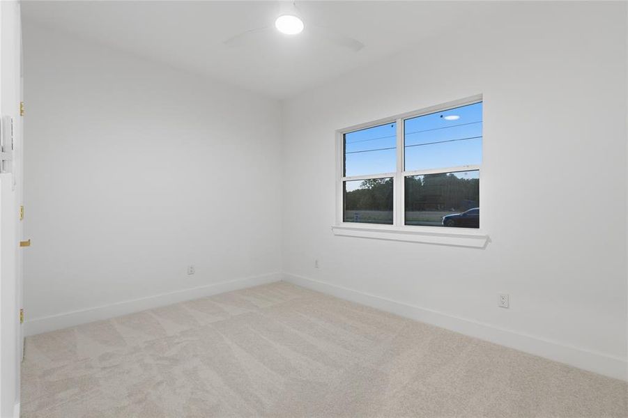 Neutral-toned carpet flooring complements the white walls and trim