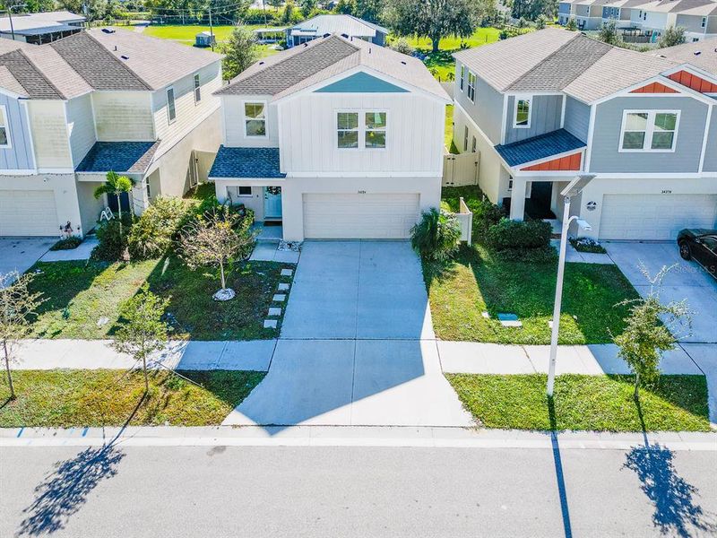 Front exterior of a new home in Pasadena Point, Wesley Chapel, FL, highlighting curb appeal (Image 27). Front exterior of a new home in Pasadena Point, Wesley Chapel, FL, highlighting curb appeal (Image 27).