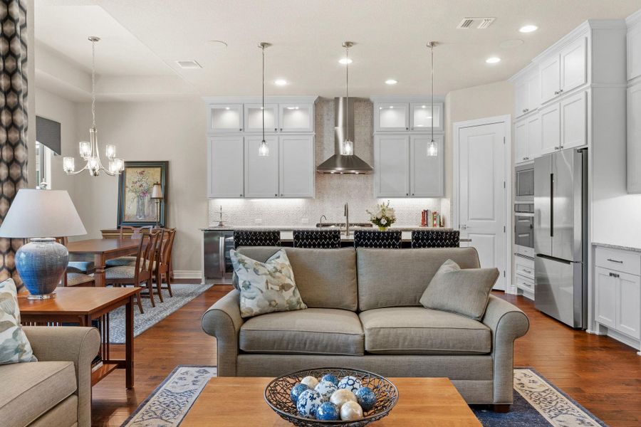The living room flows seamlessly into the kitchen and dining spaces for easy gathering. The living room flows seamlessly into the kitchen and dining spaces for easy gathering.