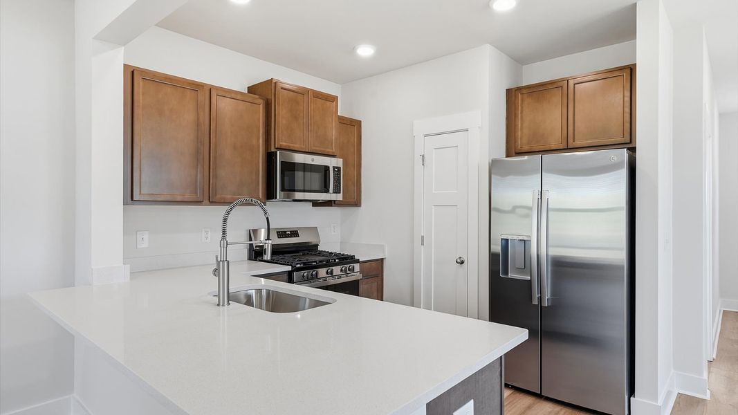 Accomplished design in a kitchen that blends function and form with a right-sized island at Clarke Townes