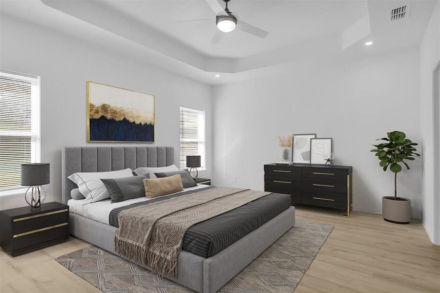 Bedroom featuring a tray ceiling, recessed lighting, light wood-style floors, and ceiling fan