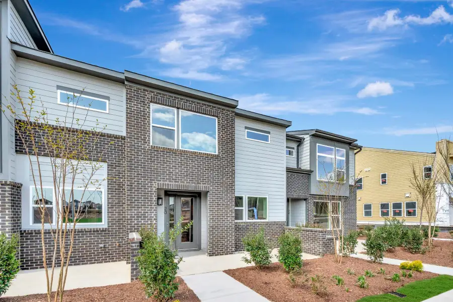 Front exterior of a new home in The Townes at NoVi, Pittsboro, NC, highlighting curb appeal (Image 2). Front exterior of a new home in The Townes at NoVi, Pittsboro, NC, highlighting curb appeal (Image 2).