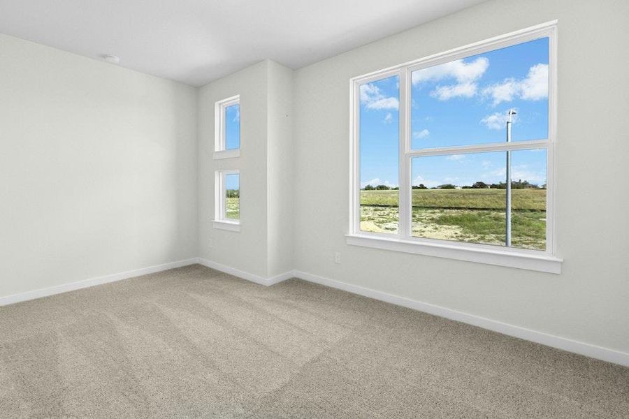 Spare room with light colored carpet and baseboards