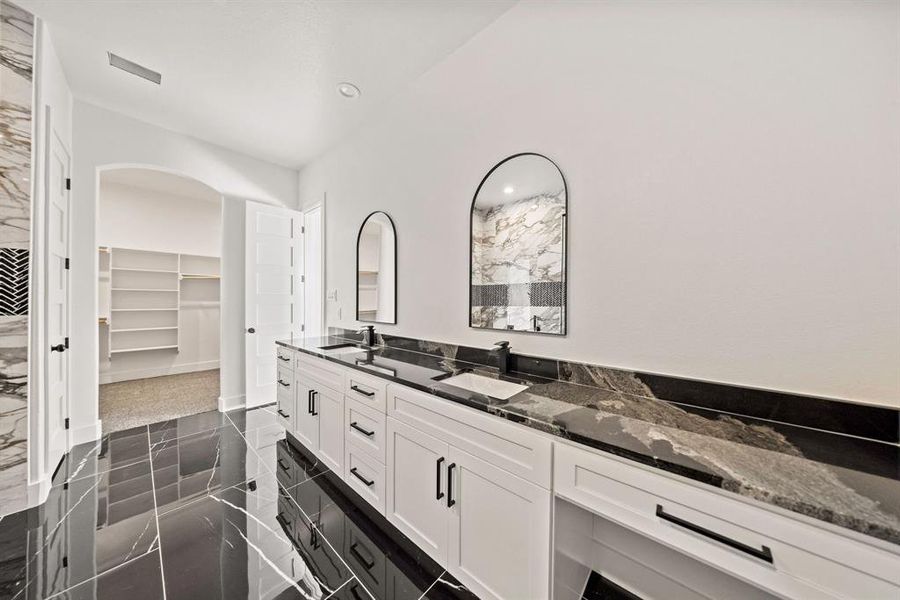 Bathroom featuring a spacious closet, double vanity, granite floors, and recessed lighting Bathroom featuring a spacious closet, double vanity, granite floors, and recessed lighting