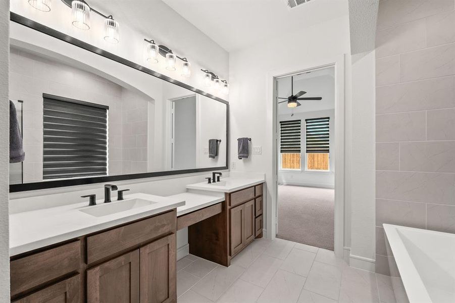 Master bath featuring two sinks, a knee space, free standing tub and separate shower Master bath featuring two sinks, a knee space, free standing tub and separate shower