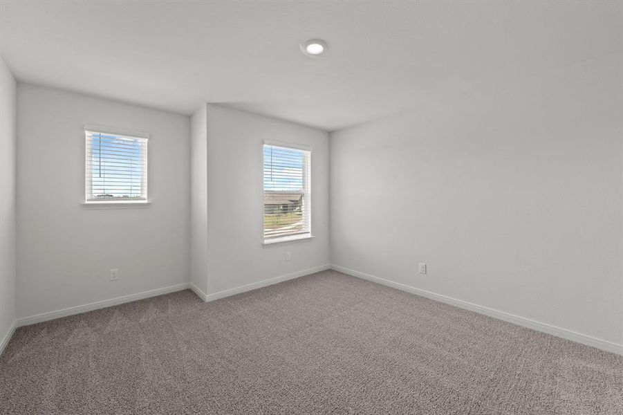 Carpeted empty room featuring baseboards and recessed lighting Carpeted empty room featuring baseboards and recessed lighting