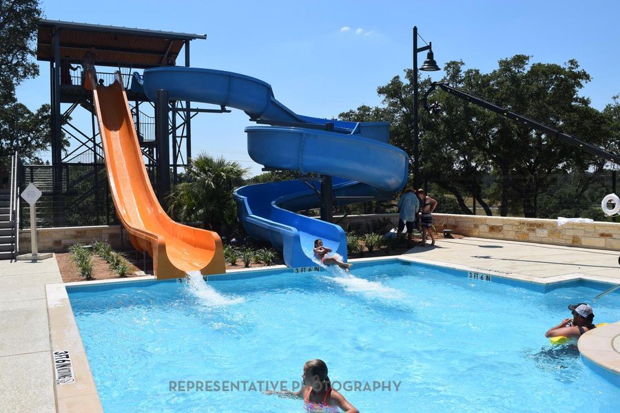 Community pool with a water slide Community pool with a water slide