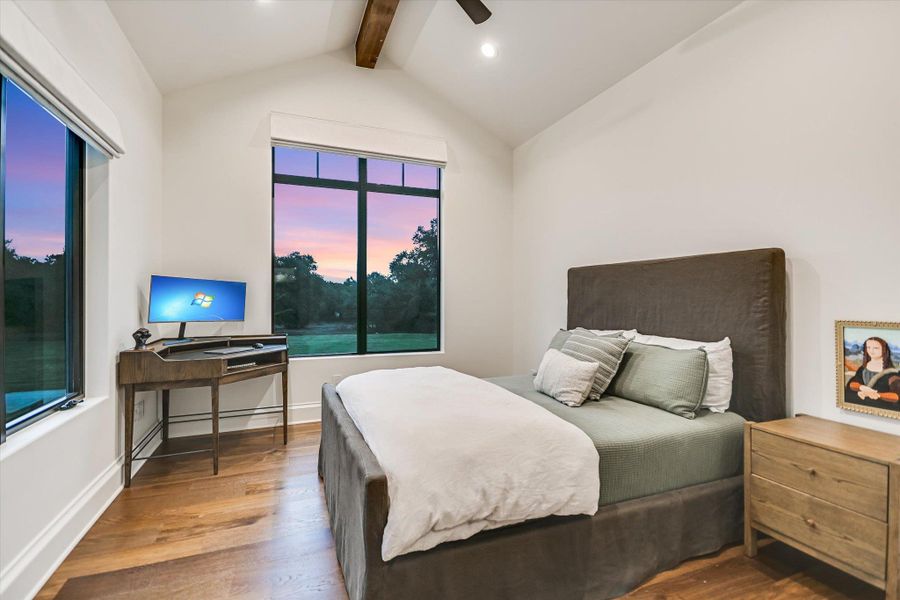 Bedroom with wood finished floors and ceiling fan Bedroom with wood finished floors and ceiling fan