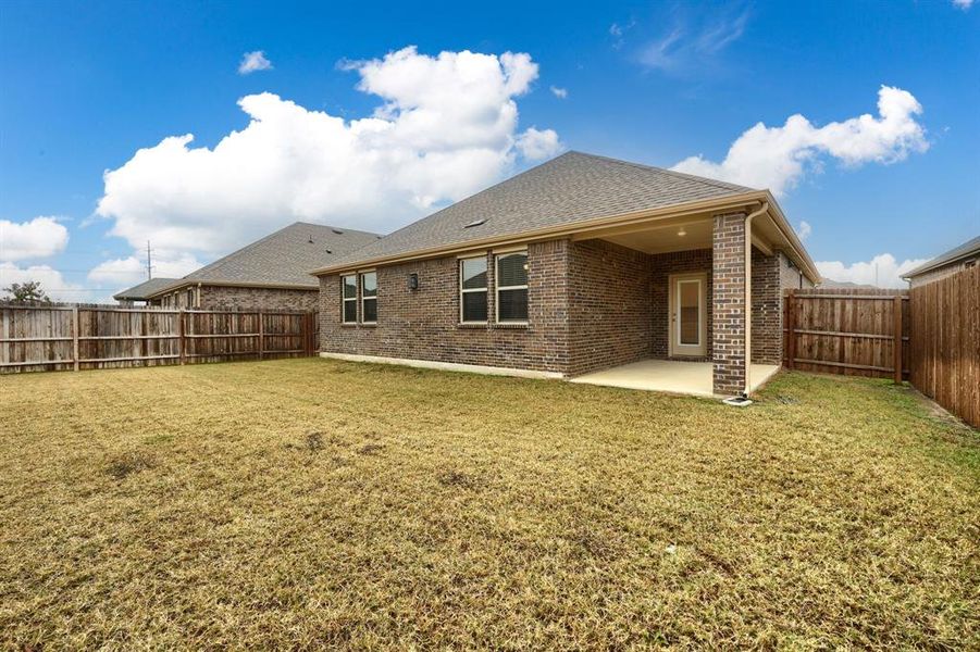 Rear view of house featuring brick siding, roof with shingles, a patio, and a fenced backyard Rear view of house featuring brick siding, roof with shingles, a patio, and a fenced backyard