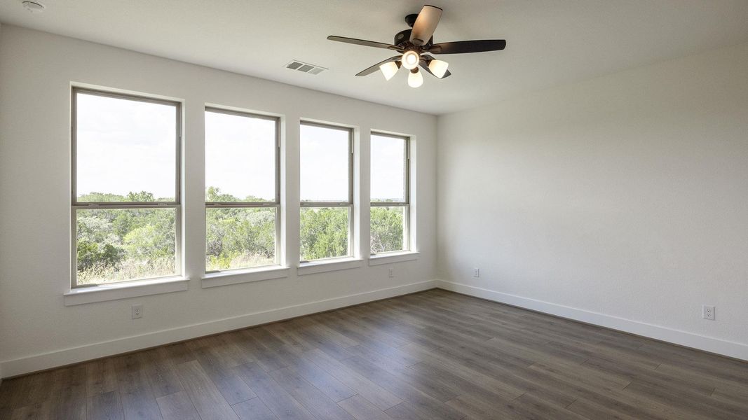 Empty room featuring dark wood-style flooring and ceiling fan Empty room featuring dark wood-style flooring and ceiling fan
