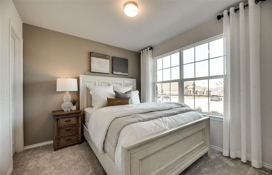 *Model Representation - Spacious secondary bedroom with large windows