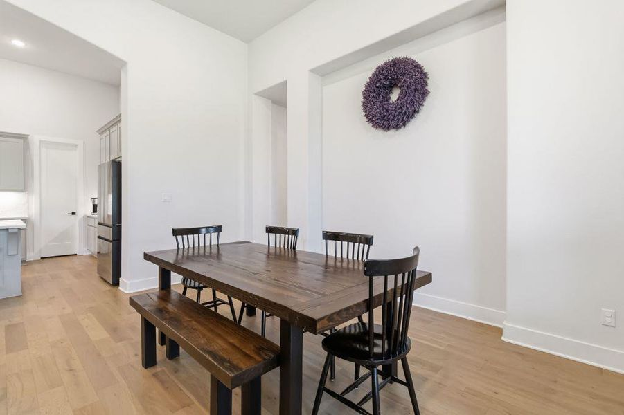 Hardwood floors stretch across this inviting dining area, perfect for entertaining guests.