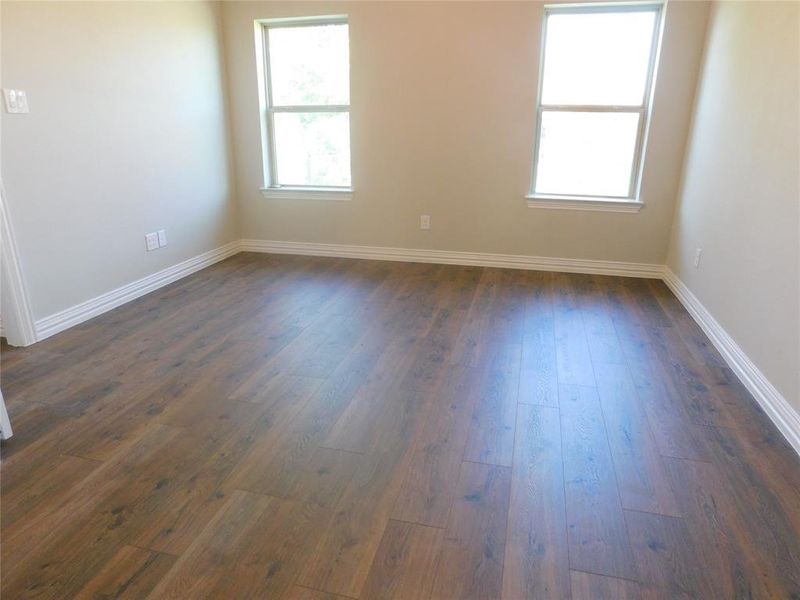 Primary bedroom looks out to backyard & creek