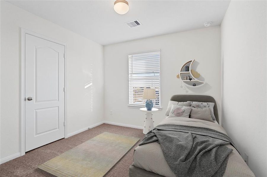 Secondary bedroom features plush carpet, neutral paint, lighting, window with privacy blinds and ample sized closet space.