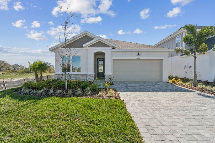 Front exterior of a new home in North River Ranch – Garden Series, Parrish, FL, highlighting curb appeal (Image 1). Front exterior of a new home in North River Ranch – Garden Series, Parrish, FL, highlighting curb appeal (Image 1).