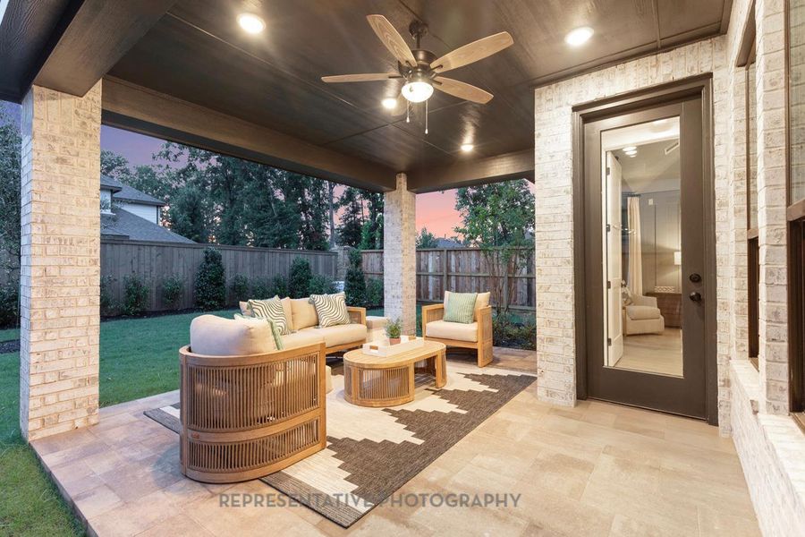 Fenced backyard with ceiling fan, a patio, and outdoor lounge area Fenced backyard with ceiling fan, a patio, and outdoor lounge area