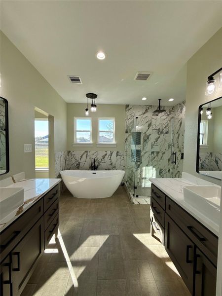 This modern bathroom features a luxurious freestanding tub, a spacious glass-enclosed shower with marble accents, dual vanities with sleek countertops, and ample natural light through large windows. This modern bathroom features a luxurious freestanding tub, a spacious glass-enclosed shower with marble accents, dual vanities with sleek countertops, and ample natural light through large windows.