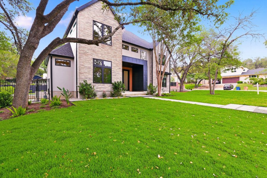 Contemporary residence featuring a stone and stucco exterior