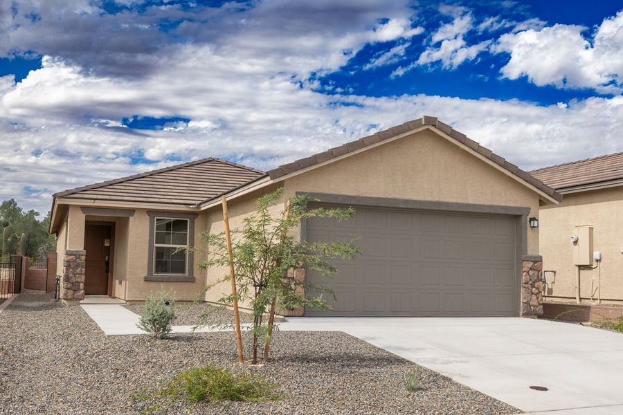 Front exterior of a new home in Vista Del Oro Reserve, Tucson, AZ, highlighting curb appeal (Image 1). Front exterior of a new home in Vista Del Oro Reserve, Tucson, AZ, highlighting curb appeal (Image 1).