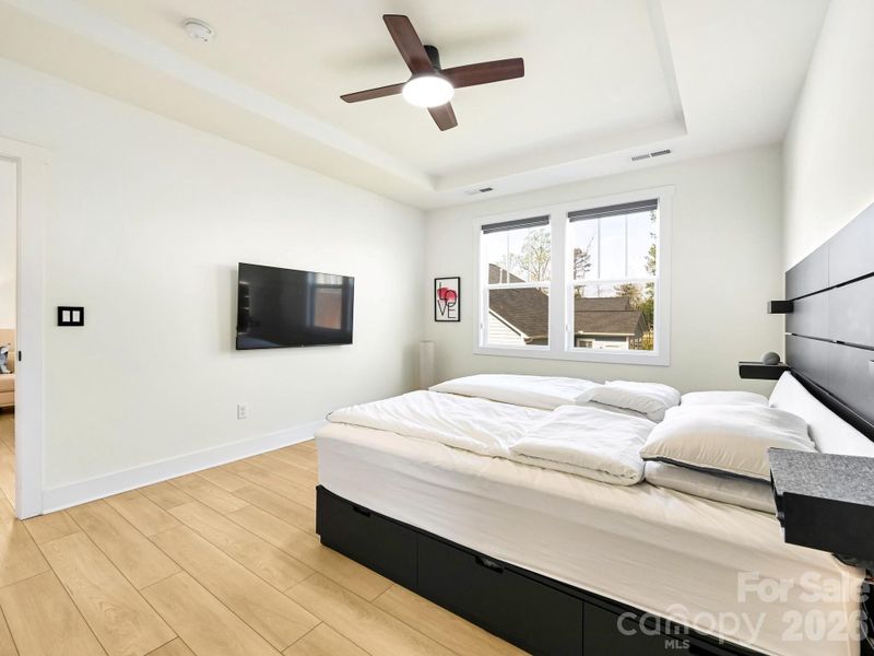 Primary bedroom. Custom light or privacy blinds. Wall mounted TV could stay.