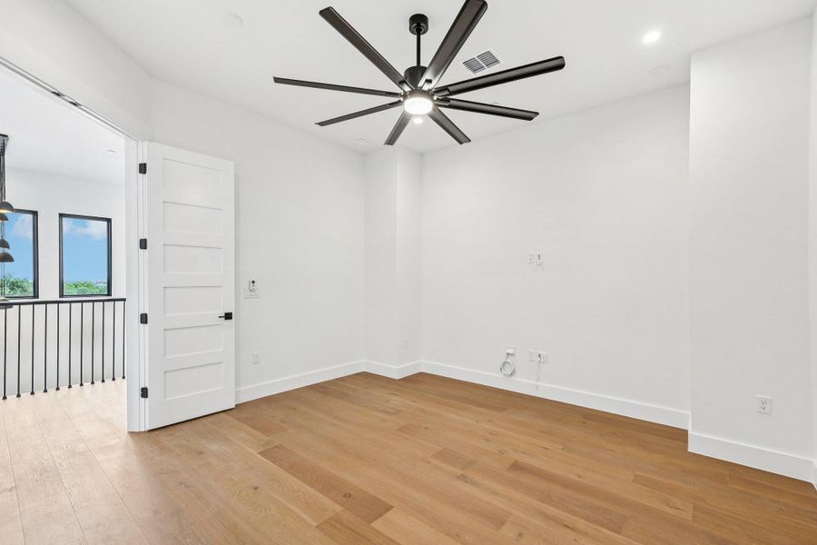 Media room with light wood-type flooring, a ceiling fan, and recessed lighting