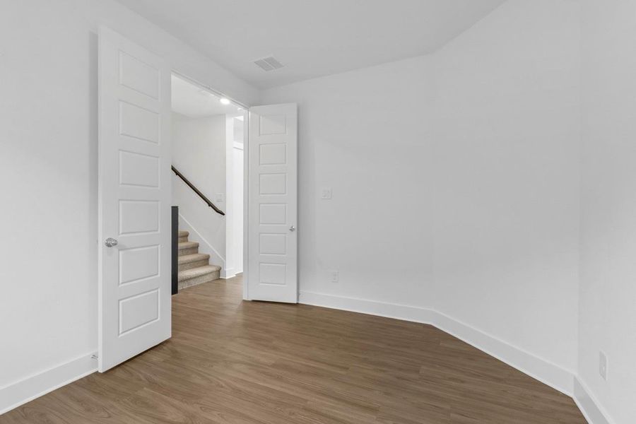 The study features elegant French doors and a large window that fills the space with natural light, creating an inspiring work environment. The study features elegant French doors and a large window that fills the space with natural light, creating an inspiring work environment.