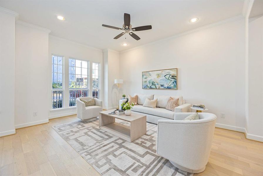 Picture yourself relaxing in this spacious living area, with a ceiling fan and peaceful views of your front yard oasis.